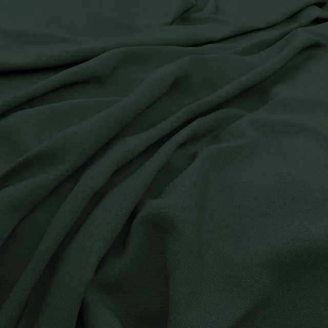 Deep forest-green slubby weave gathered into soft, shadowed fabric folds