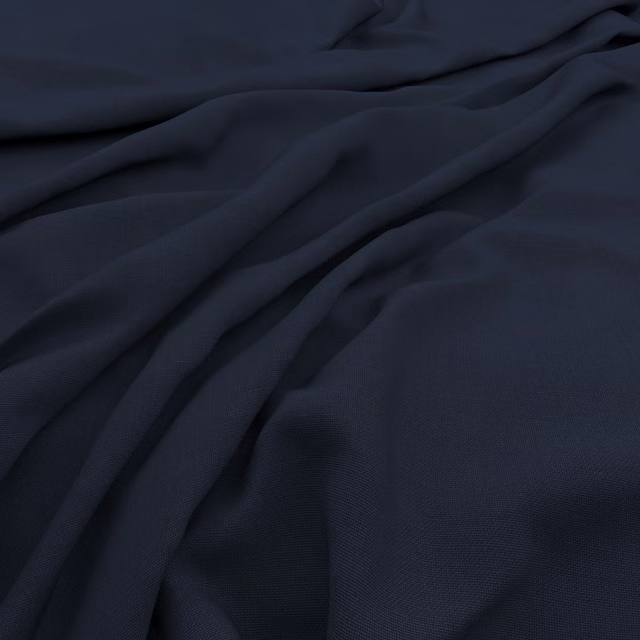 Deep indigo textile with fine slubby weave and softly gathered matte folds