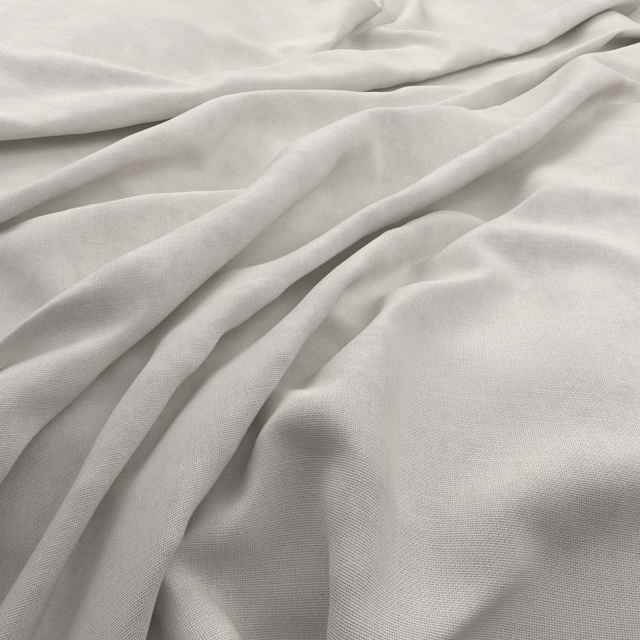 Soft ivory woven fabric gathered into fluid folds with a subtle slubby texture