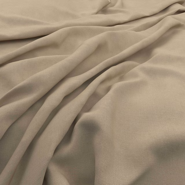 Warm papyrus-beige fabric with fine slubs, soft folds and a close plain weave