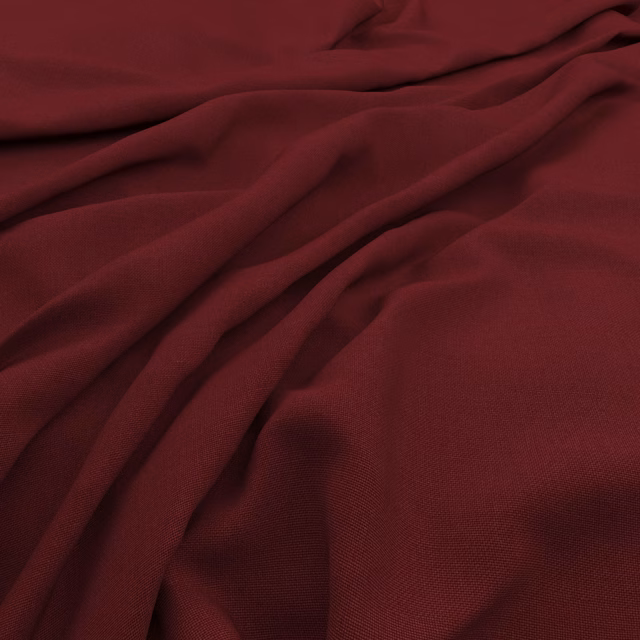 Deep pomegranate textile with a fine slubby weave in soft, shadowed folds
