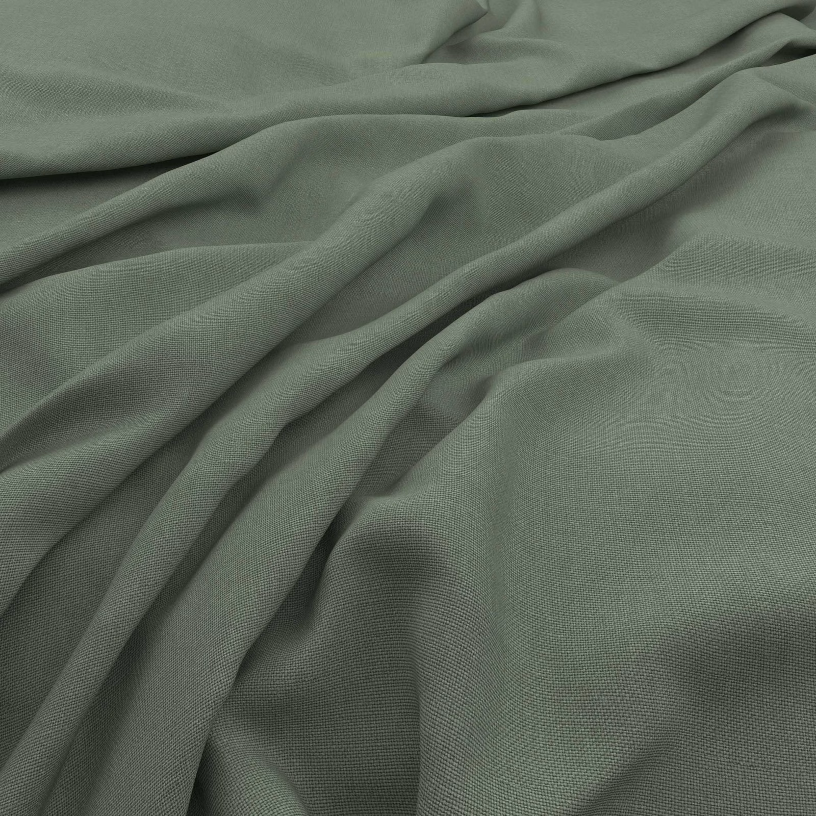 Muted sage green slubby fabric shown in fluid folds with a fine woven texture