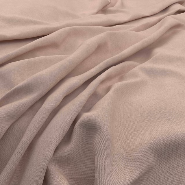 Soft shell pink slubby weave shown in flowing folds with subtle dusty rose shadows