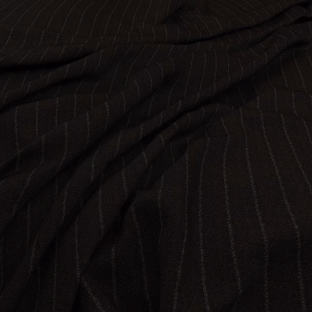 Deep ebony fabric with subtle charcoal vertical striations and softly folded woven texture