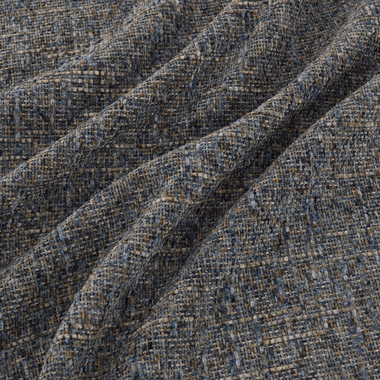 Charcoal grey woven fabric with blue, taupe and brown flecks in angled folds