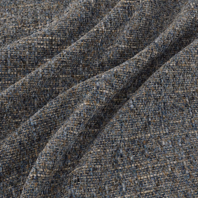Charcoal grey woven fabric with blue, taupe and brown flecks in angled folds