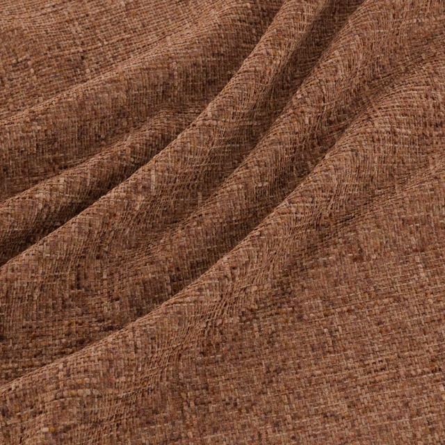 Warm chestnut-brown woven fabric with irregular slub texture in folded drape
