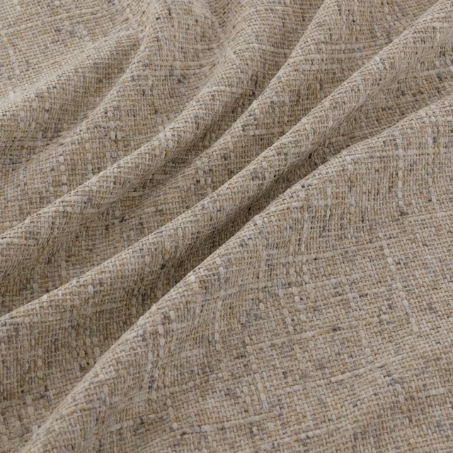 Warm beige woven fabric with taupe flecks, fine crosshatch texture and softly folded surface