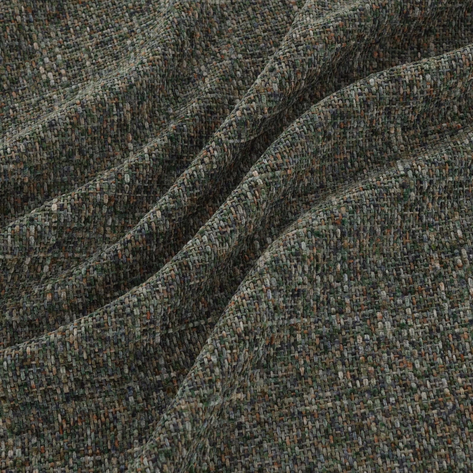 Deep pine-green woven fabric with grey, brown and sage flecks in a nubby texture
