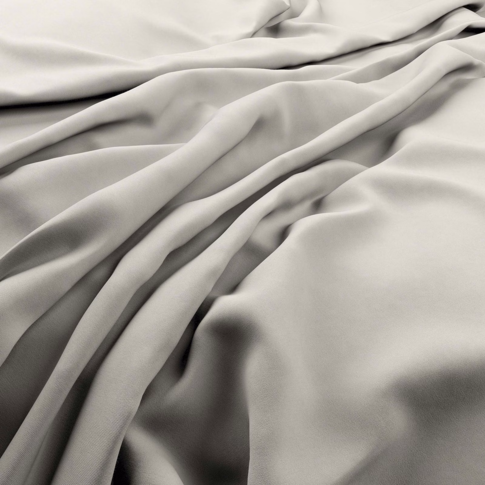 Pale beach-beige fabric in fluid folds with a gentle surface sheen