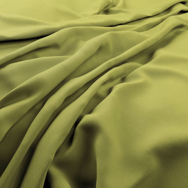 Smooth yellow-lime fabric gathered into lustrous folds with deep olive shadows