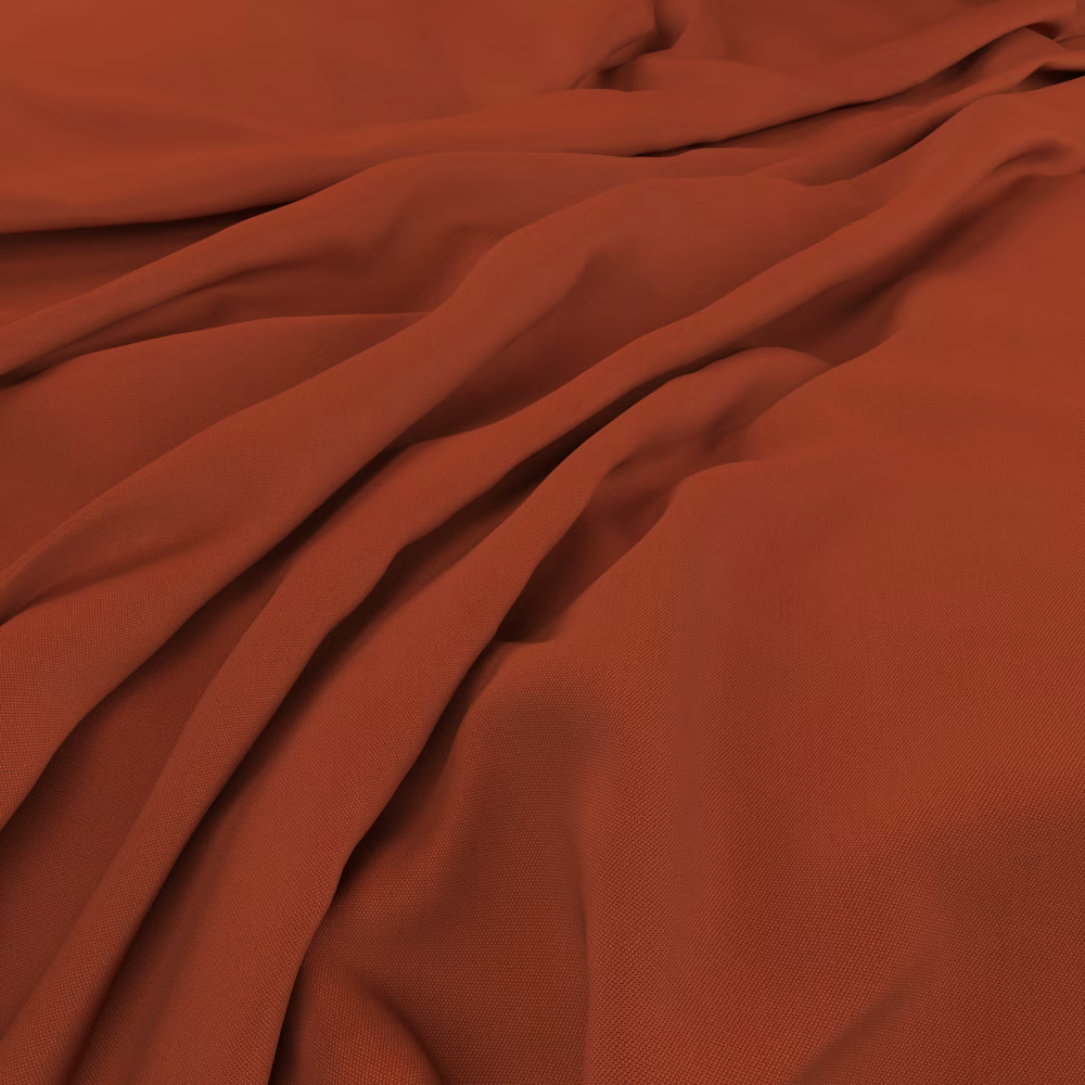Warm lobster-red fabric with a fine weave falling into deep fluid folds