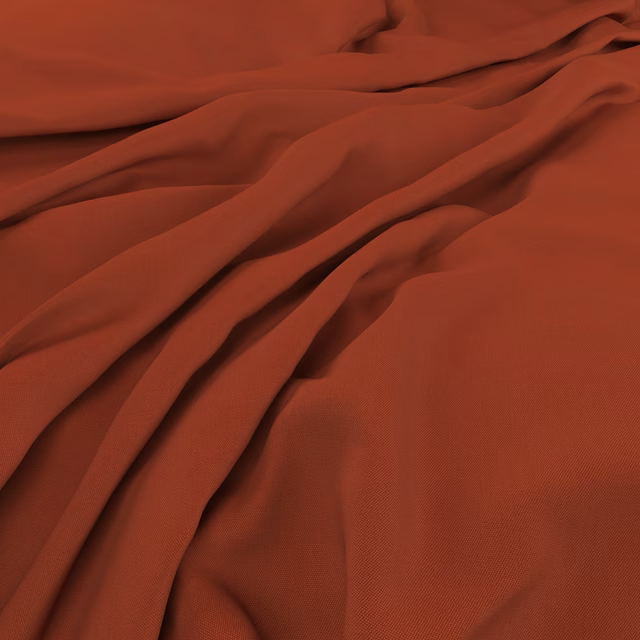Warm lobster-red fabric with a fine weave falling into deep fluid folds