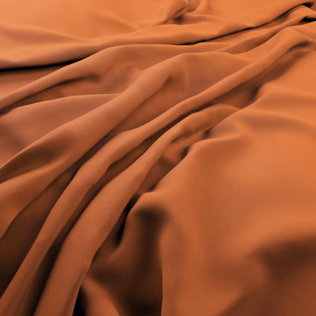 Warm mandarin-orange cloth with smooth sheen, gathered into deep fluid folds