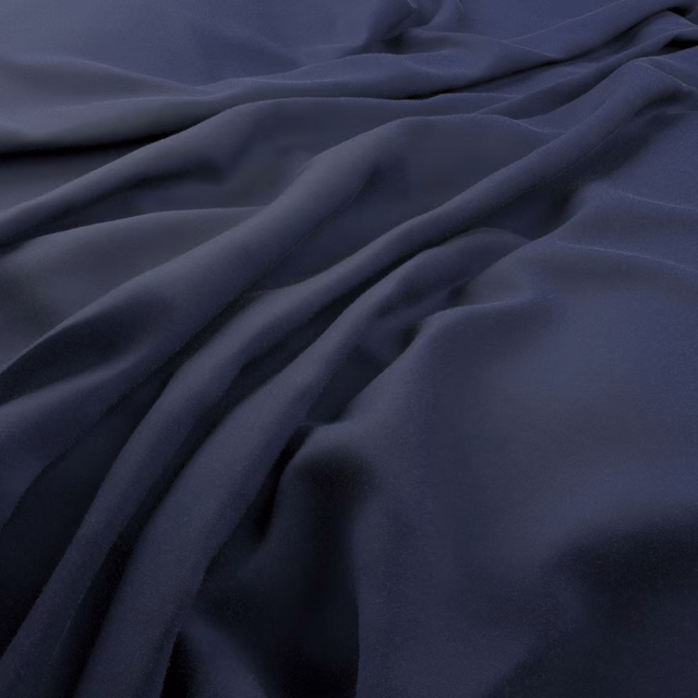 Deep marine-blue fabric shown in smooth, flowing folds with blue-black shaded creases