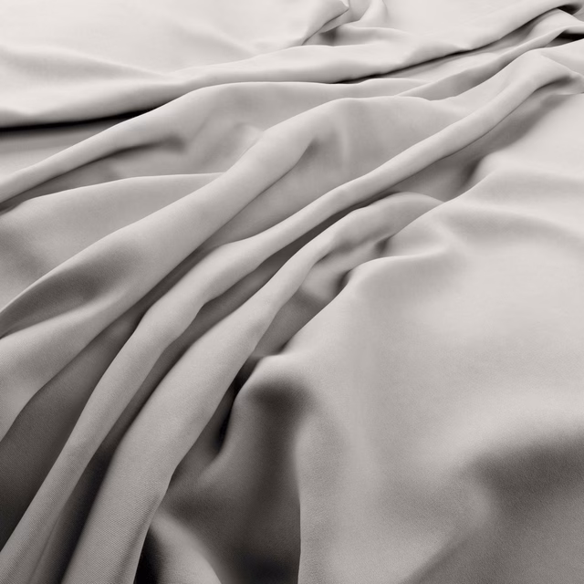 Pale mist-grey fabric with smooth satin-like sheen falling into soft folds