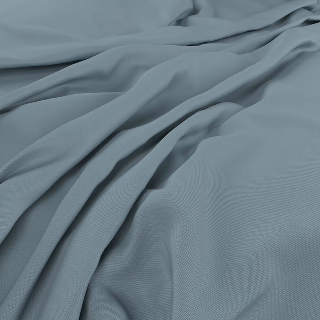 Muted blue-grey fabric falling in soft folds with a fine, smooth weave