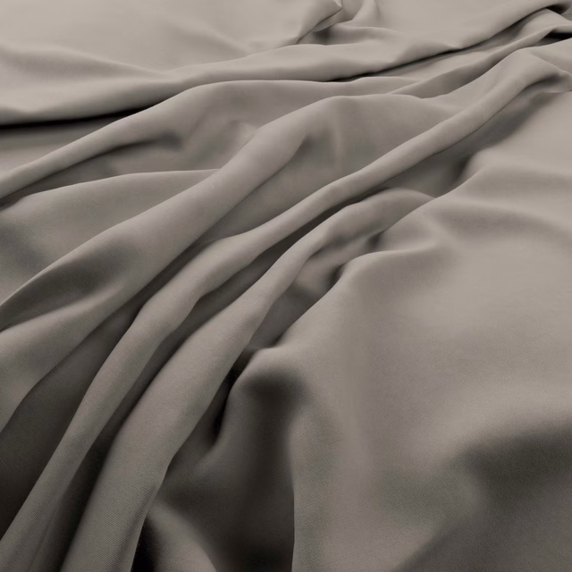 Smooth pebble taupe-grey fabric falling in soft, fluid folds