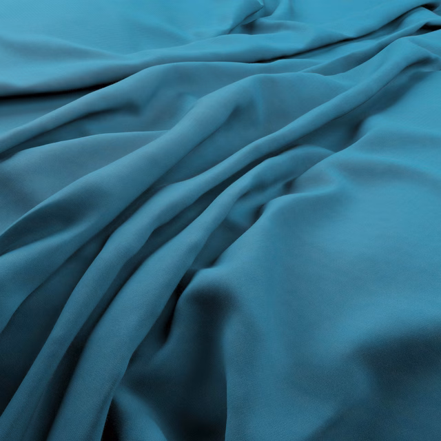 Smooth deep turquoise-teal fabric gathered into flowing folds with subtle sheen