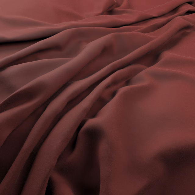 Deep berry-red fabric gathered into smooth, softly lustrous flowing folds