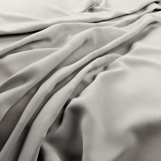 Pale shell-ivory smooth fabric gathered into softly lustrous flowing folds