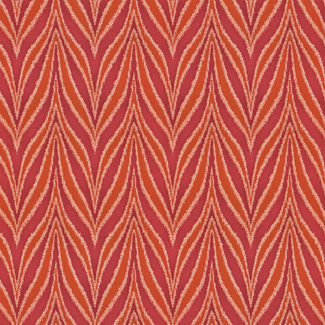 Warm coral-red woven textile with cream and blush geometric chevrons