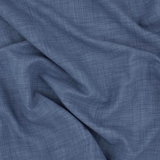 Muted cobalt-blue fabric with a fine crosshatched weave folded into soft ripples