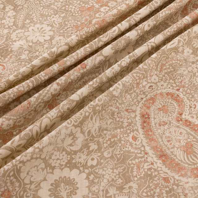 Oatmeal paisley fabric with ivory florals and dusty coral accents in soft folds