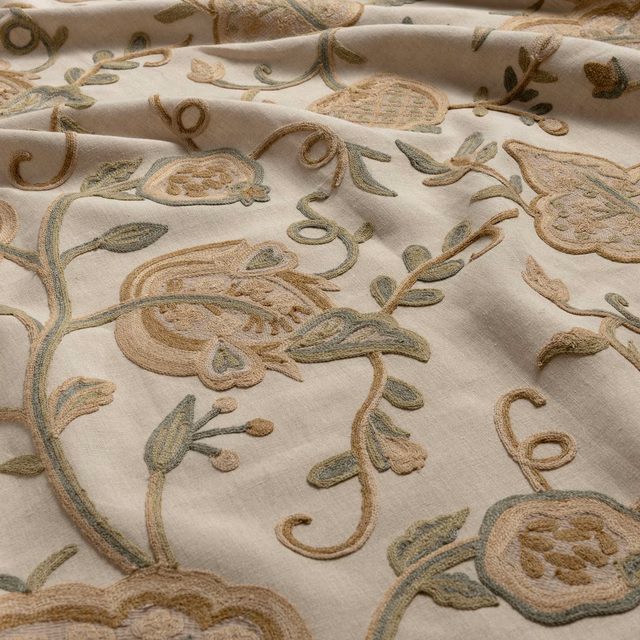 Warm ivory fabric with sage, taupe and ochre raised scrolling florals
