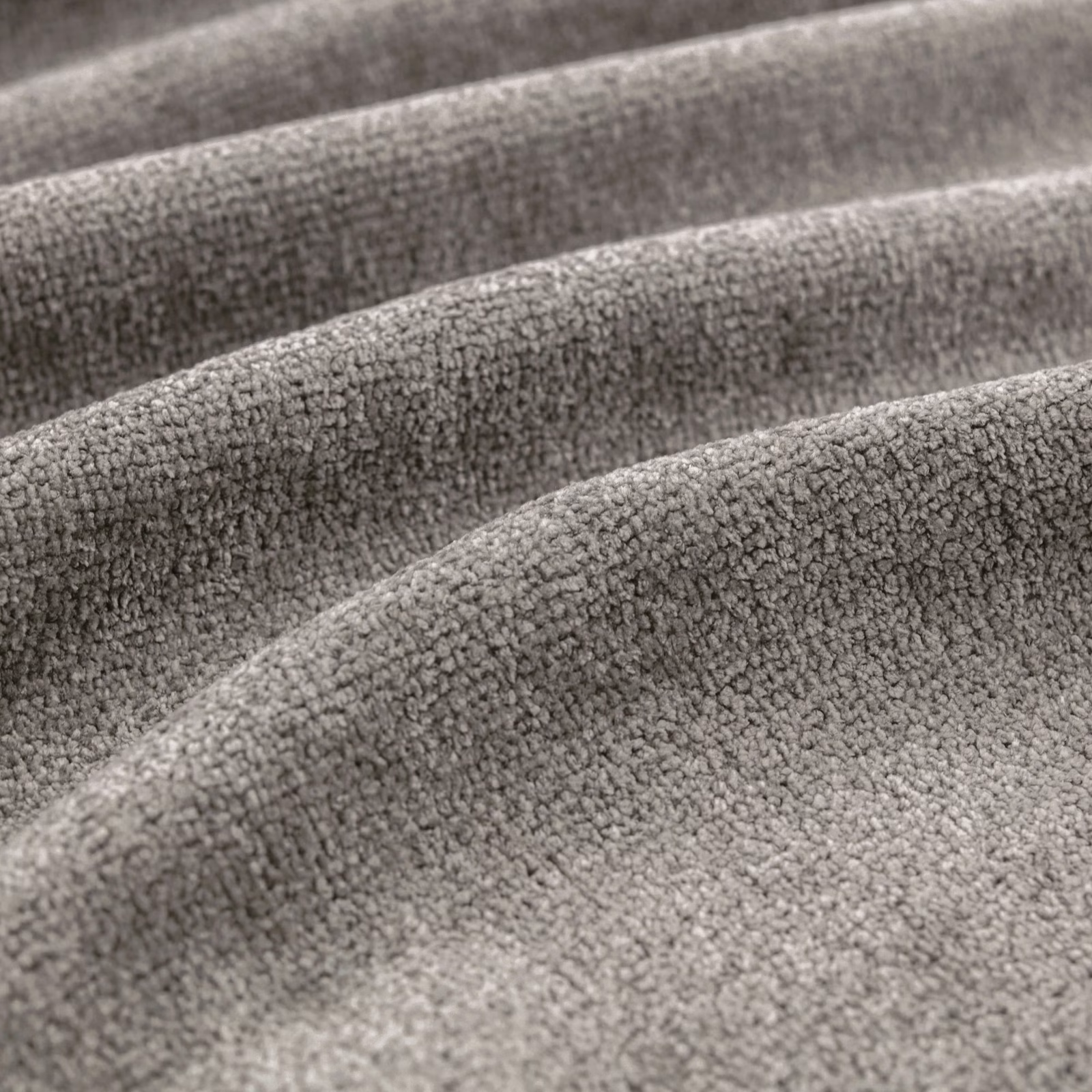 Close-up of dove-grey nubby fabric draped in softly rounded folds