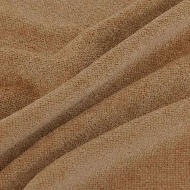 Warm camel-tan nubby fabric folded to reveal a dense, softly uneven weave
