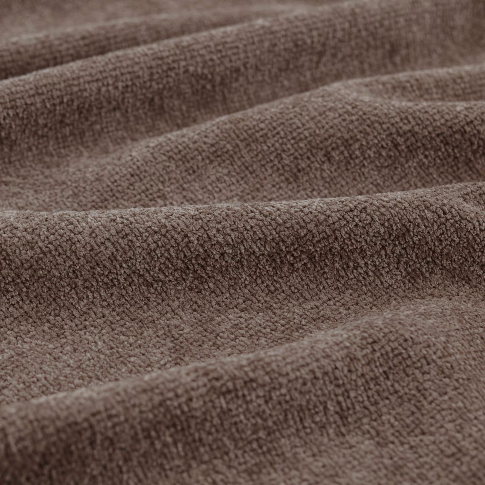 Warm mocha-brown nubby fabric folded into softly rounded ridges