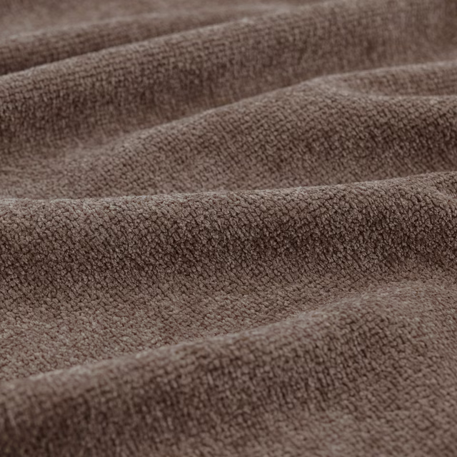 Warm mocha-brown nubby fabric folded into softly rounded ridges