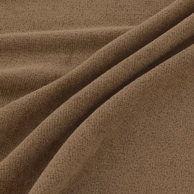 Warm nut-brown close-loop fabric folded into softly textured diagonal drapes
