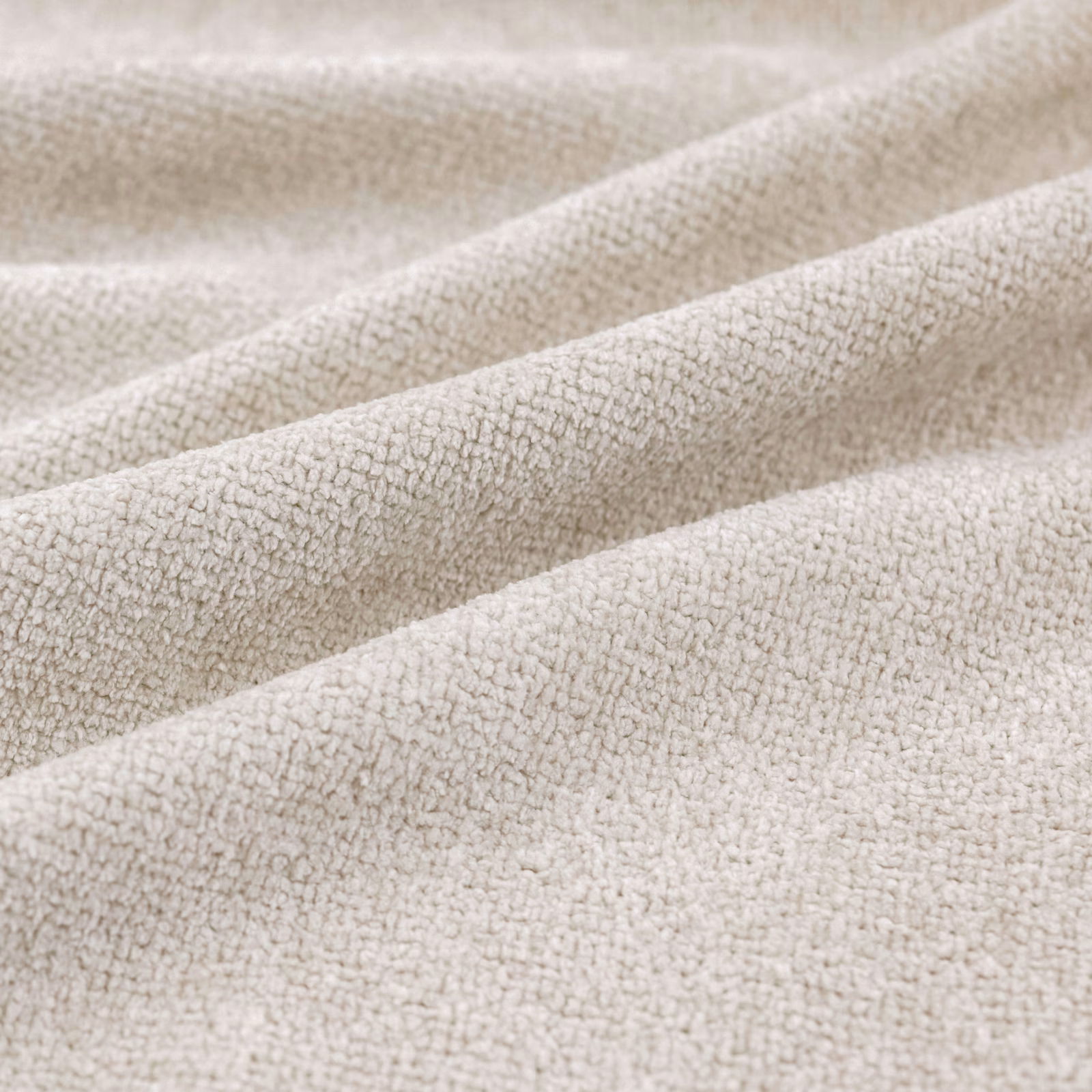 Warm oyster cream upholstery with fine pebble texture falling into soft folds