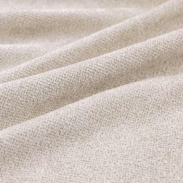 Warm oyster cream upholstery with fine pebble texture falling into soft folds