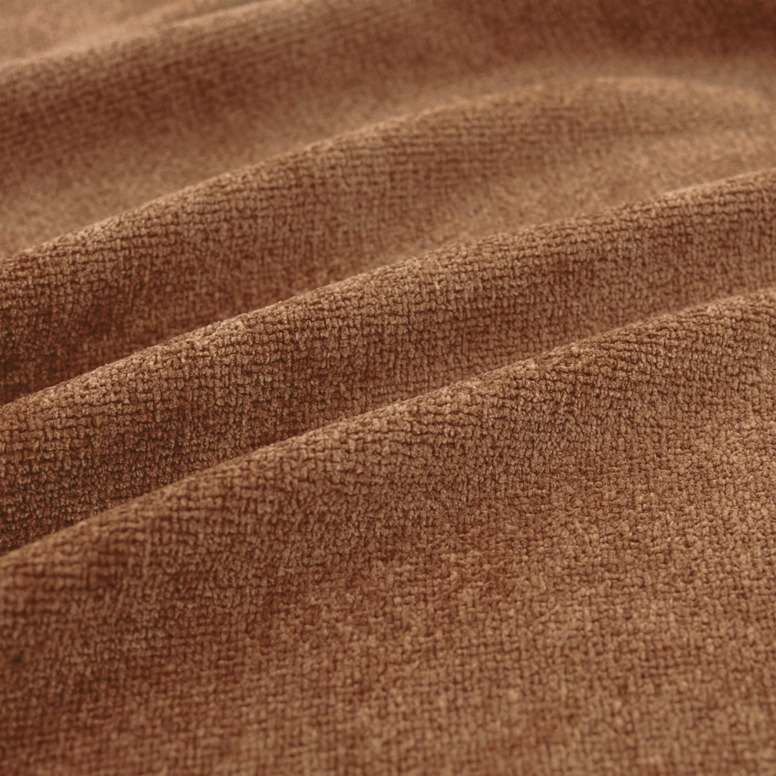 Warm rust-brown fabric with fine nubby texture arranged in broad, softly shaded folds