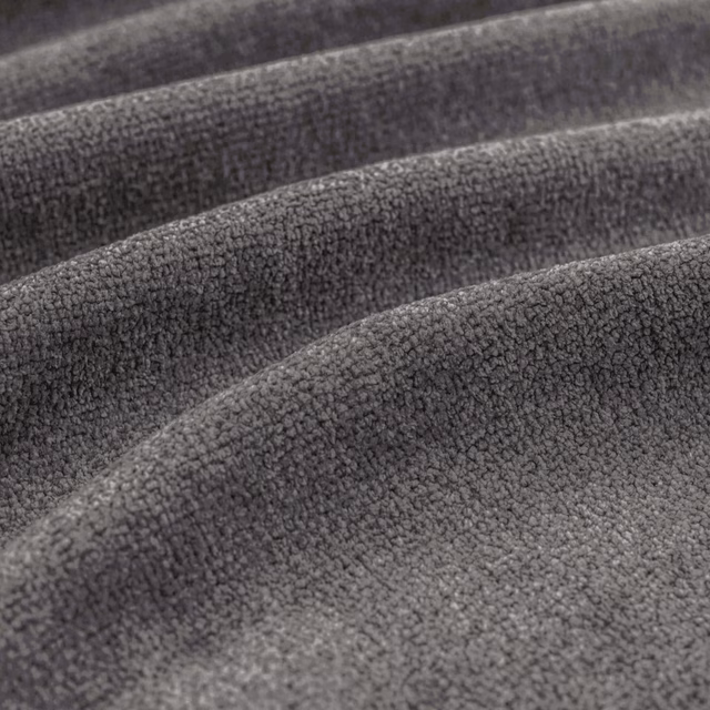 Close-up of cool charcoal-grey fabric showing dense nubby pile and sculpted folds