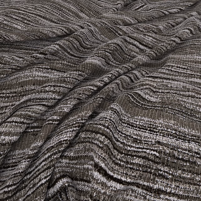 Charcoal and ivory Swirl Oreo fabric with rippling woven stripes and a folded surface