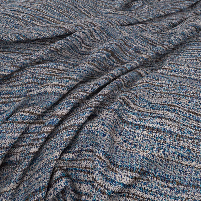 Muted seafoam and blue-grey woven fabric with rippling charcoal wave bands and nubby texture