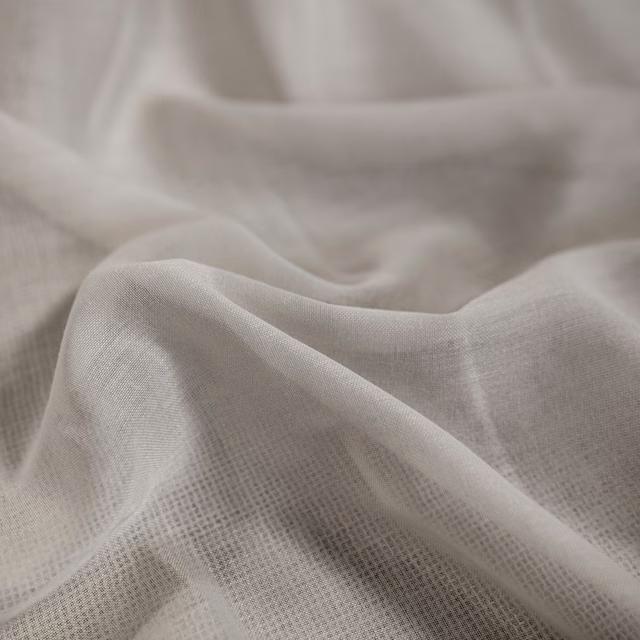 Soft ivory open-weave fabric gathered into lightly translucent flowing folds