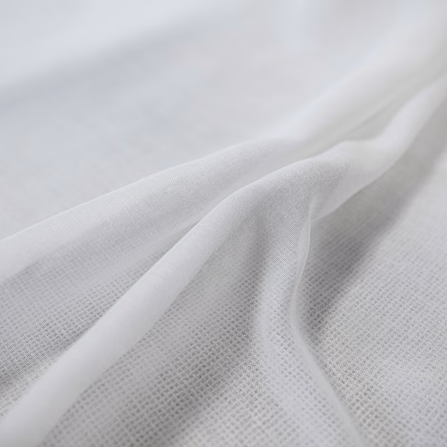 Cool white fabric with a fine open weave draped into soft flowing folds