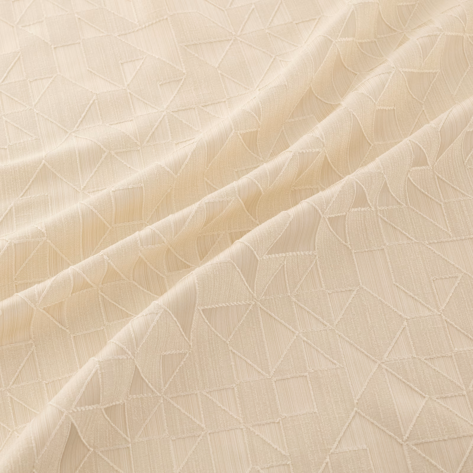Warm ivory fabric with raised angular lines and softly gathered folds