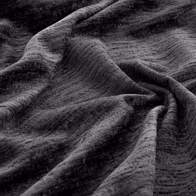Close-up of charcoal-grey Torino fabric with rippled ridges gathered into deep folds