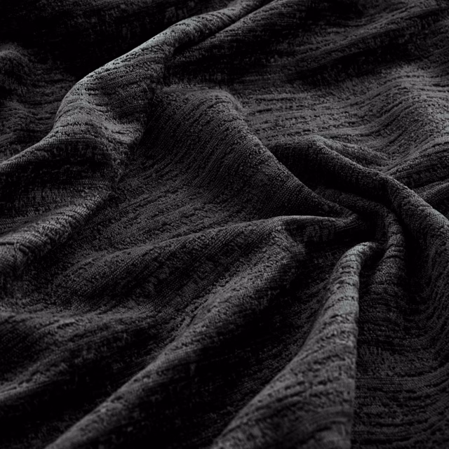 Near-black Torino textile with rippled charcoal ridges folded into deep shadows