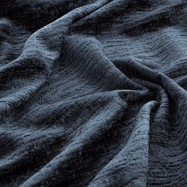 Deep navy fabric with irregular raised ridges folding into blue-grey highlights