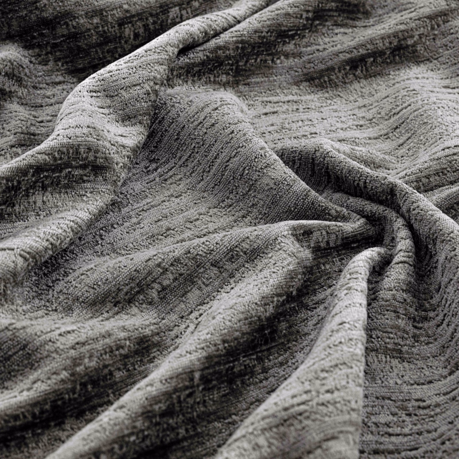 Close-up of nickel-grey textile showing charcoal ripples and raised woven texture