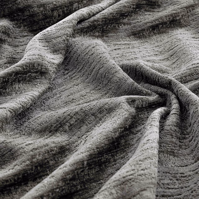 Close-up of nickel-grey textile showing charcoal ripples and raised woven texture
