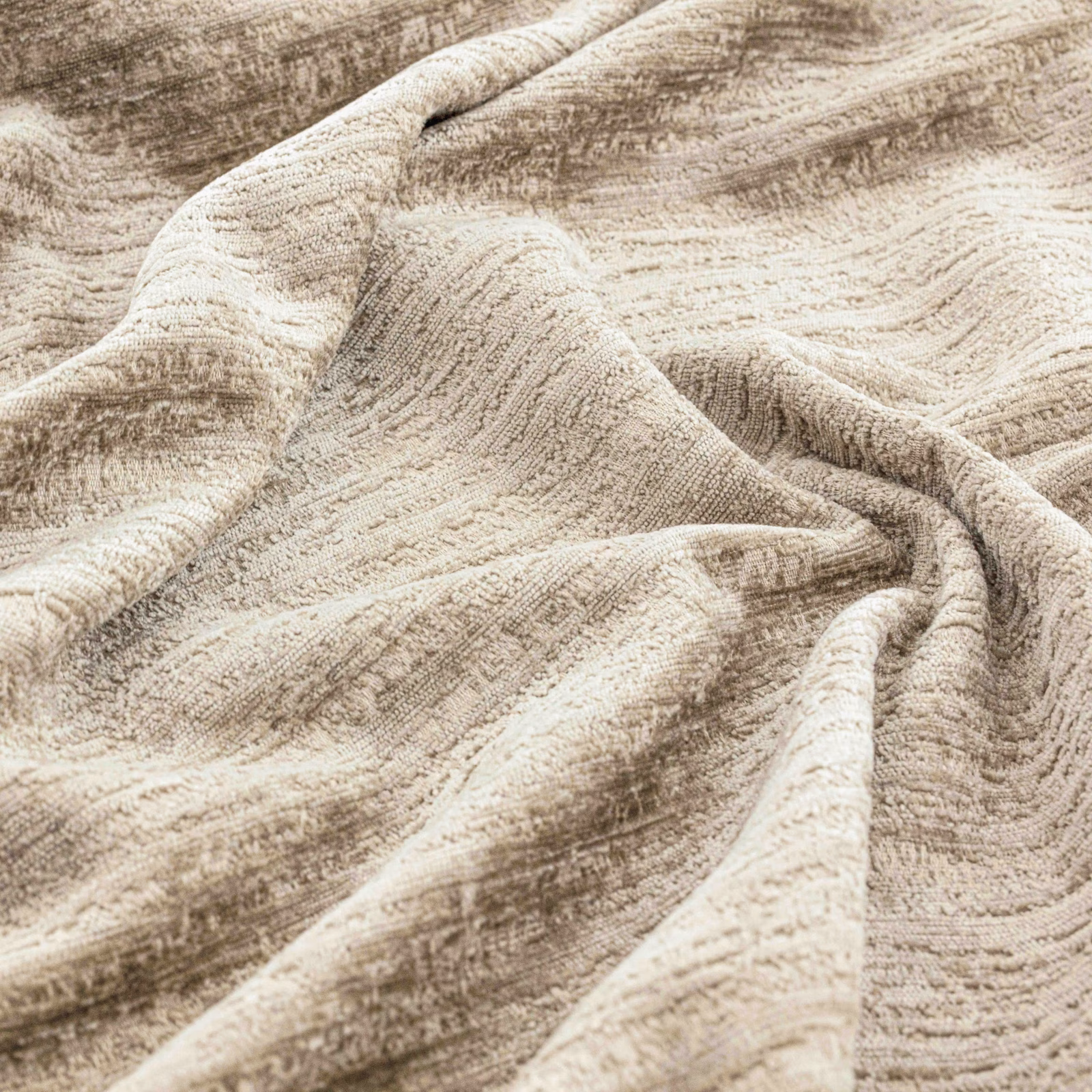 Warm greige striated woven fabric gathered into softly textured folds