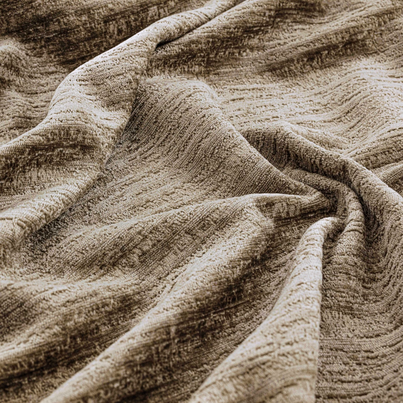 Warm taupe textured fabric with flowing brown striations gathered into soft folds